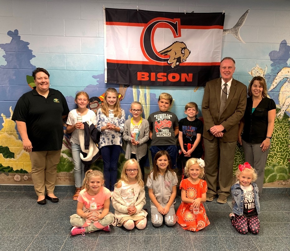 In the first row are:  Zoey Rosenbaum, Libby Albright, Ally Gibson, Reese Sankey and Toree Sankey. In the second row are: Bobbie Johnson (CCAAA), Kailynn Sankey, Emma Jacob, Bailee Jacob, Caleb Gibson, Collin Forcey, Mr. Ken Veihdeffer (CAE principal) and Stefanie Sattesahn (CAES school nurse). (Provided photo)