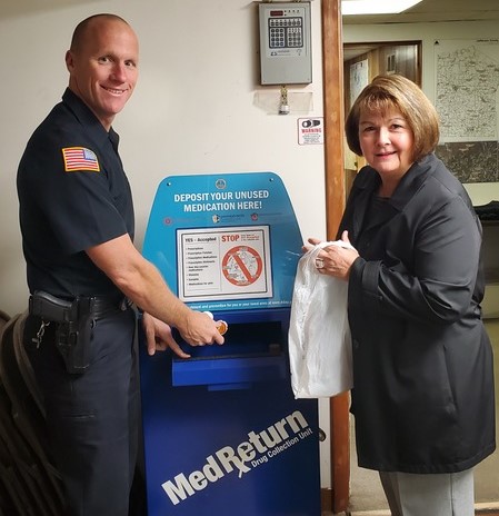 Area resident Toni Houston brings unwanted medication to the Brockway Borough Police Department during National Prescription Take Back Day on Oct. 26. Also pictured is Brockway Police Department Chief Terry Young.  (Provided photo)