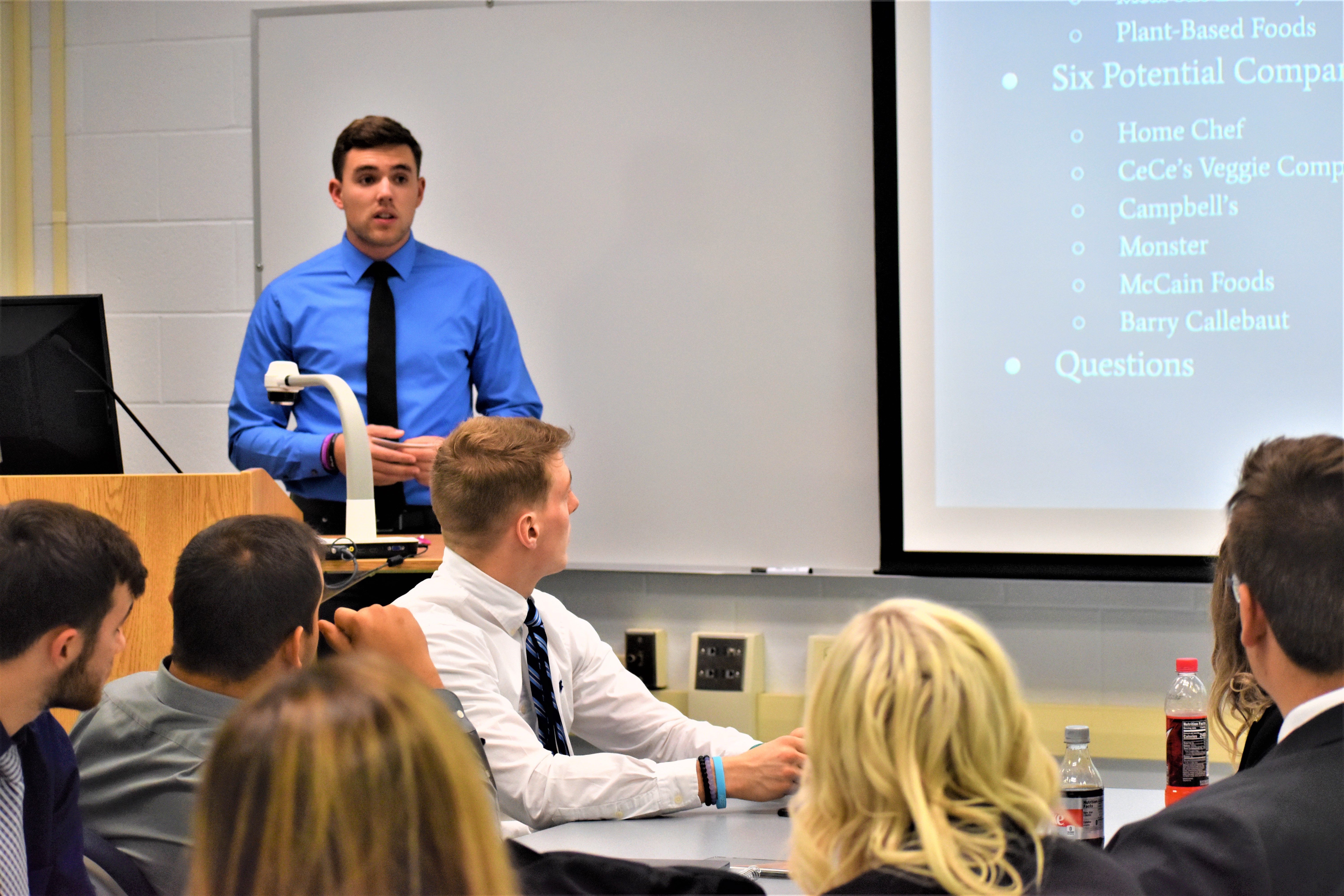 Noah Rankin, at the podium, was among the business students who presented potential ways to spur economic growth to representatives from Clearly Ahead Development. (Provided photo)