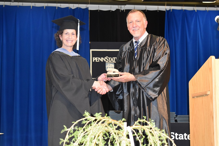 Assistant Teaching Professor LuAnn Demi receives her DEF Educator of the Year Award from DEF president Craig Ball during spring commencement ceremonies at Penn State DuBois.  (Provided photo)