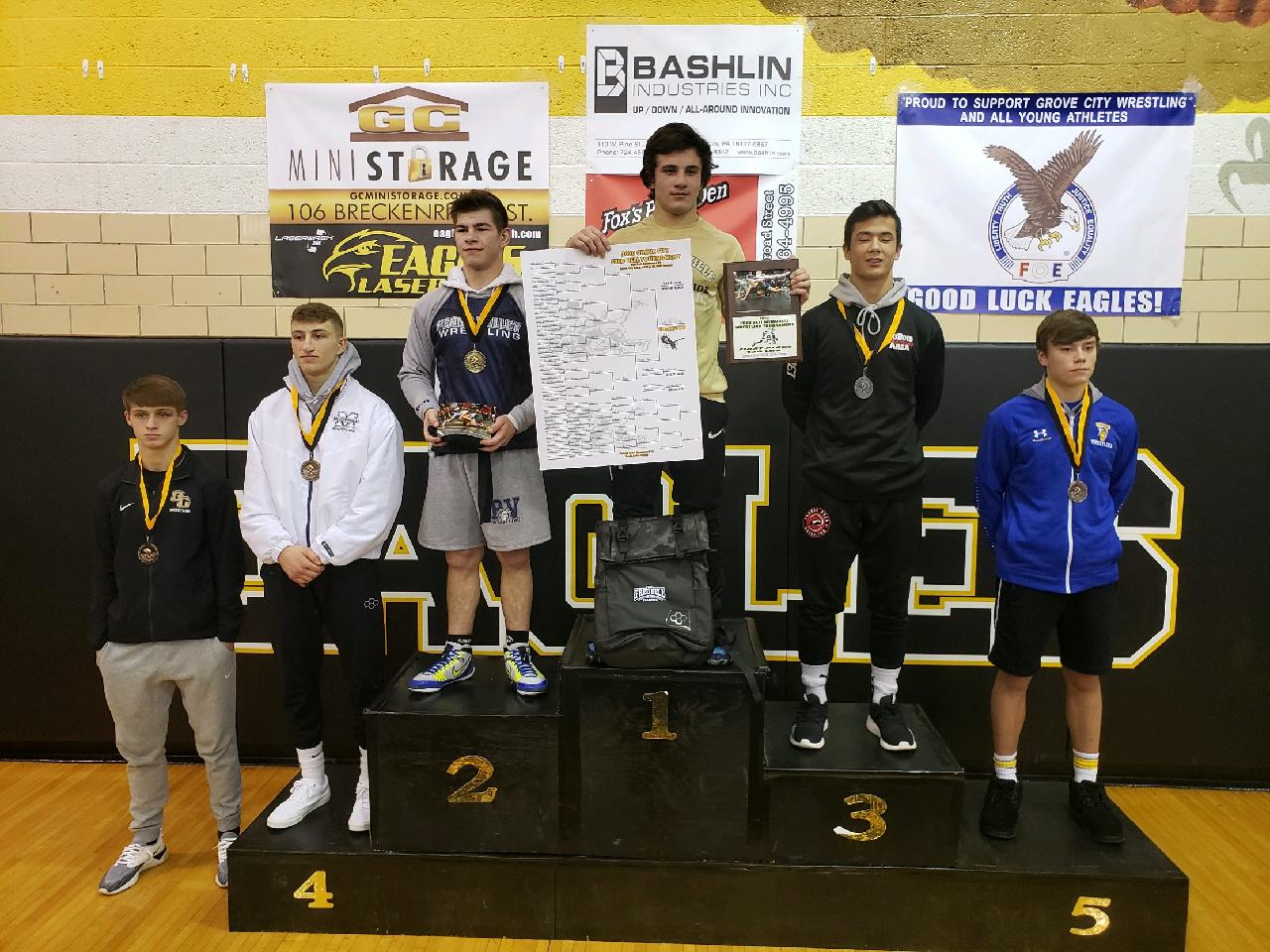 Zach Holland on top of the 138 pound podium
