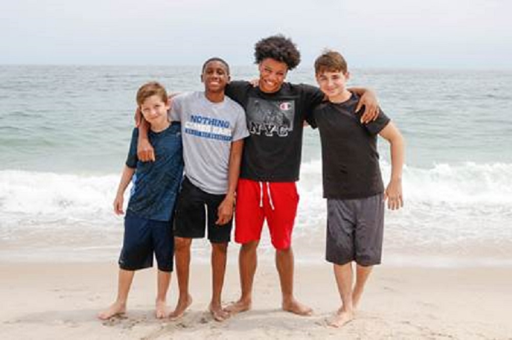 Asah, of the Bronx, and Jalon, of Brooklyn, spend a day at the beach with their Fresh Air brothers Christopher (left) and Nicholas (right). Photo Credit: Julia Comerford
