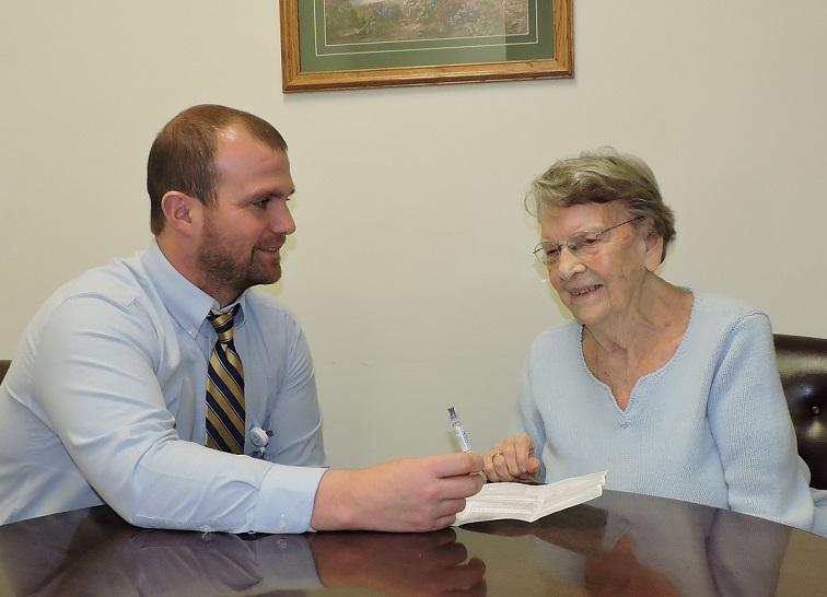Vaccinations are simple way to avoid diseases at every age, including after age 65. Shown is Thomas Yeager, PharmD, pharmacy manager, Penn Highlands Clearfield, talking to Tharon “Mauzzy” Mohney about vaccines. (Provided photo)