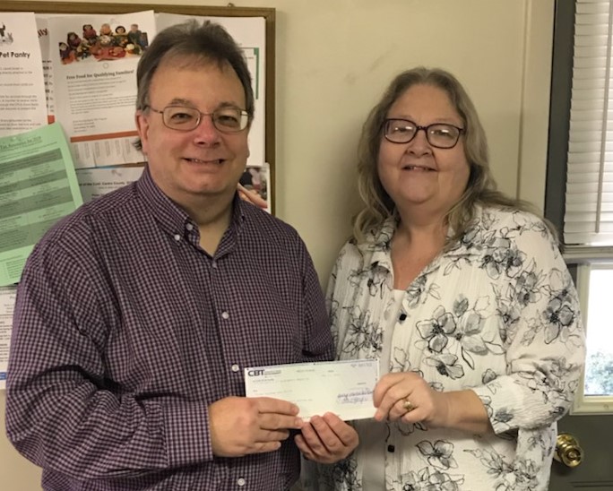 CCCF Executive Director Mark B. McCracken presents a check to Robin Knepp of the Philipsburg Food Pantry.   The Philipsburg location was added by the Clearfield County Charitable Foundation Board for support this year. (Provided photo)