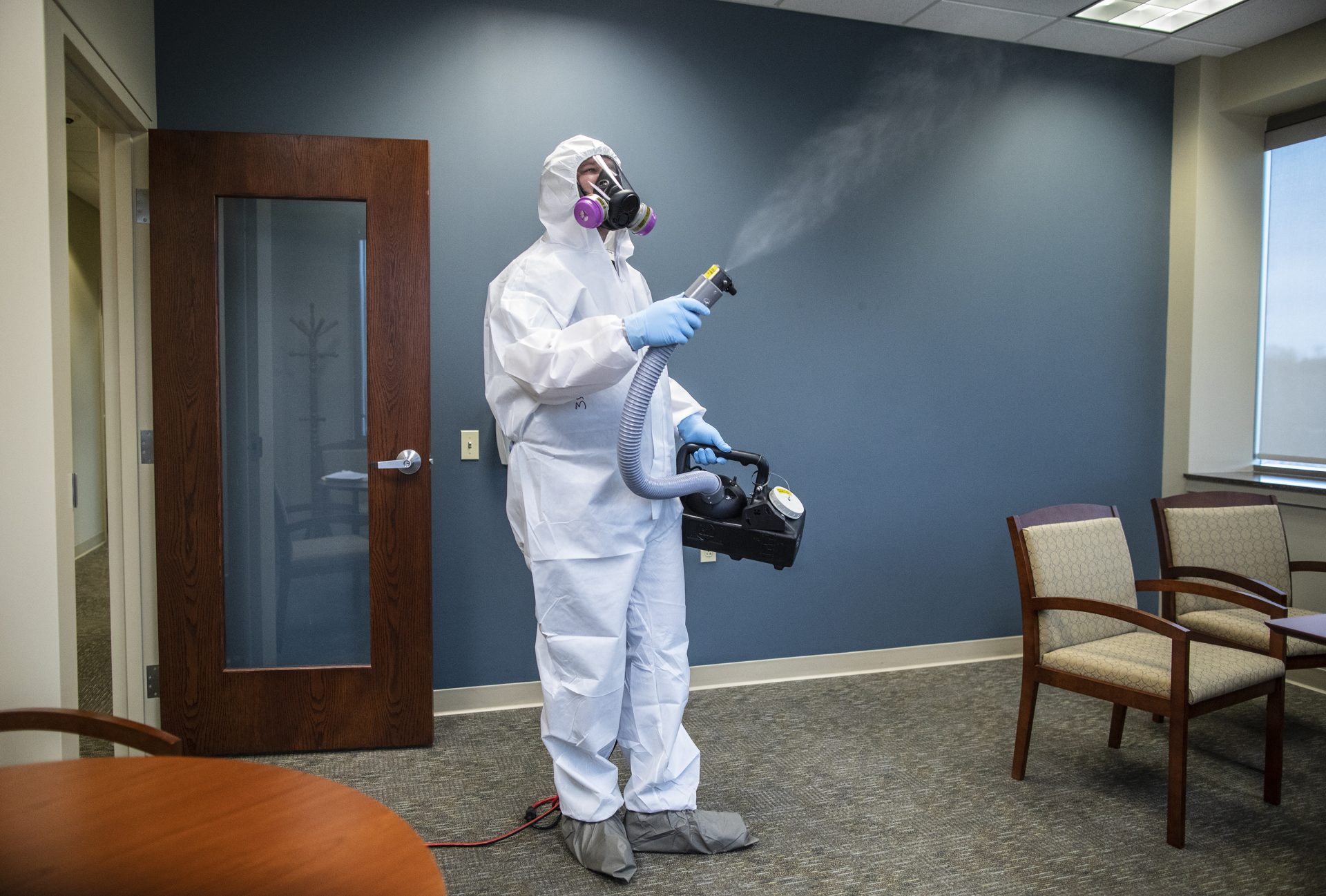 Service 1st Restoration worker Nick Hamilton sprays disinfectant throughout the Centric Bank corporate headquarters on March 25, 2020, to stop the spread of the coronavirus. Service 1st works with a number of local corporations by going to their buildings after hours and spraying the buildings.

Sean Simmers / PennLive