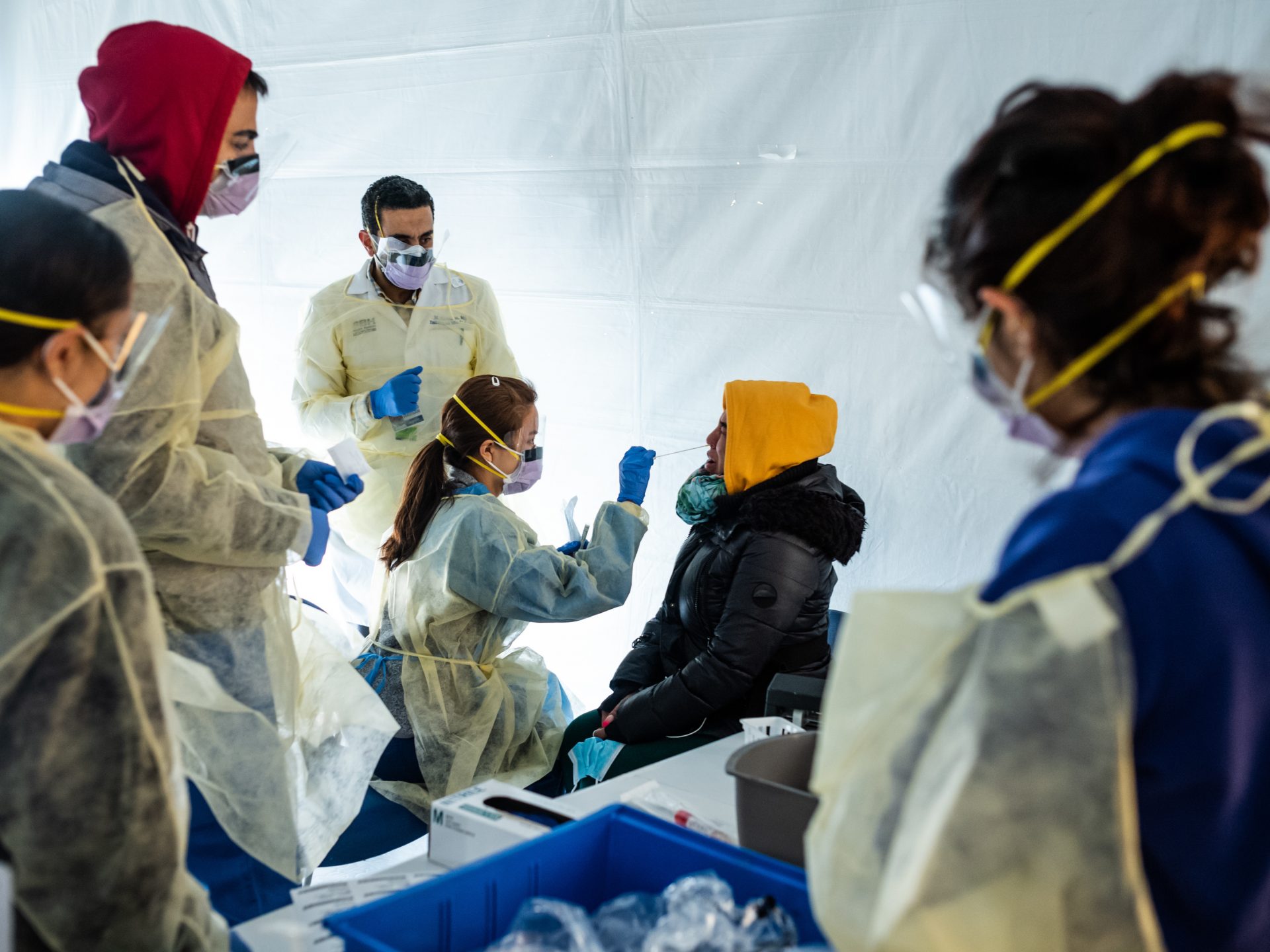 Doctors test a hospital staffer Tuesday for coronavirus, in a triage tent that's been set up outside the E.R. at St. Barnabas hospital in the Bronx. Hospital workers are at higher risk of getting COVID-19, and public health experts fear a staffing shortage in the U.S. is coming.