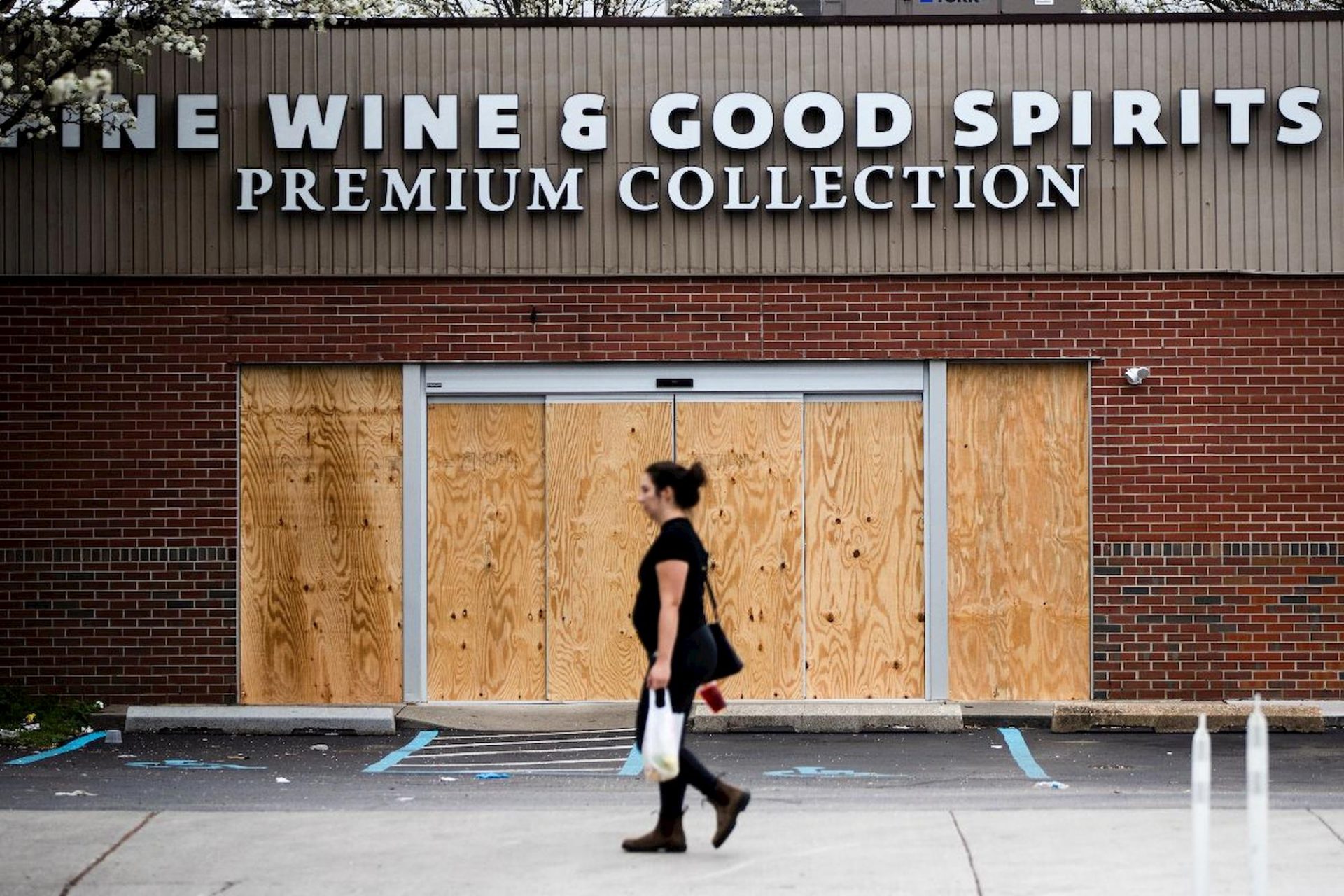 A pedestrian walks past a boarded up Wine and Spirits store in Philadelphia, Friday, March 20, 2020.

Matt Rourke / AP Photo