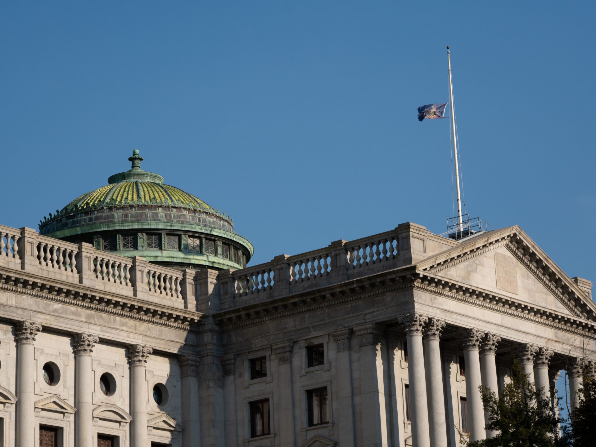 The Pennsylvania state flag flies at half-mast atop the capitol building on Oct. 31, 2018.

 Tom Downing / WITF