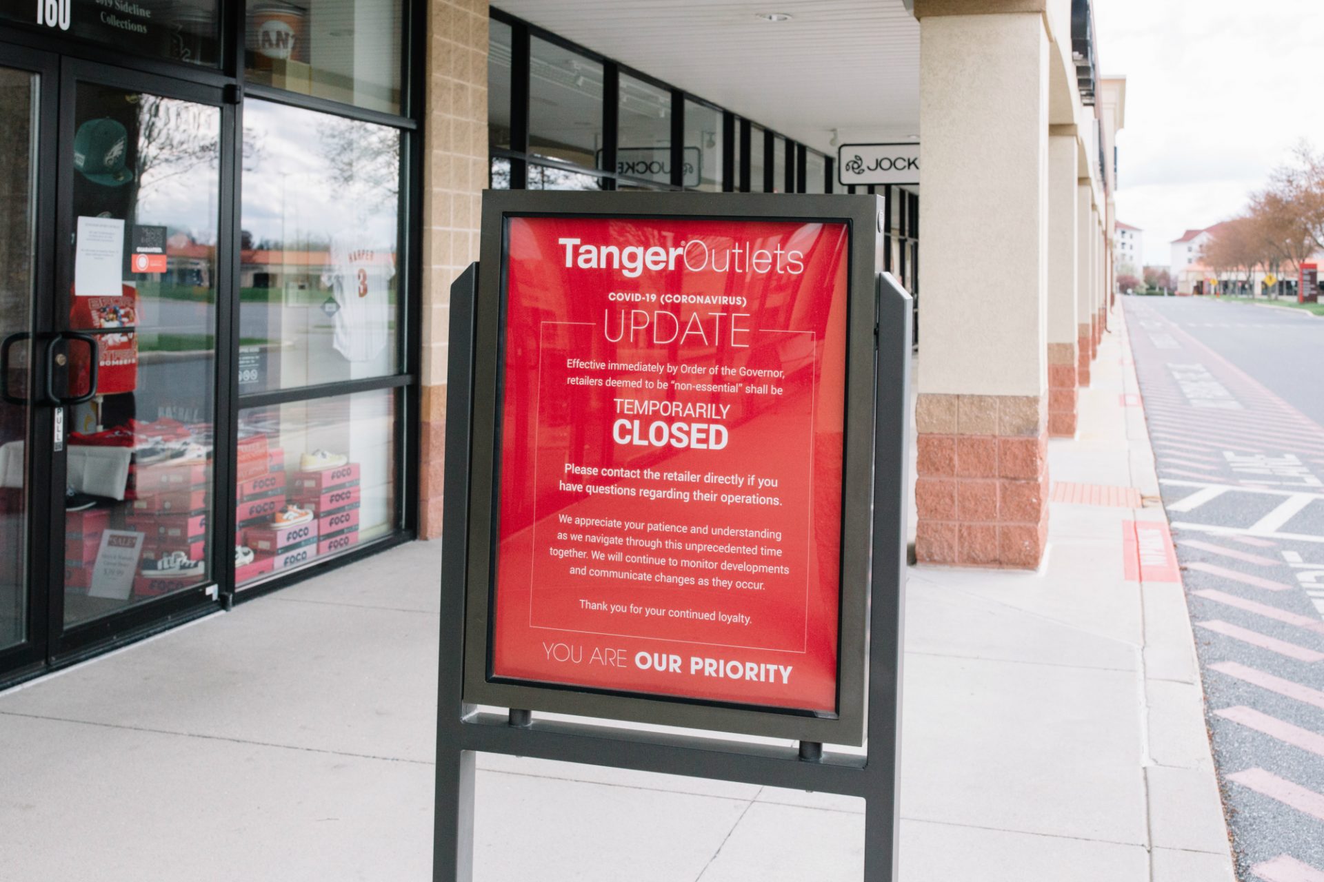 A sign announces that stores at the Tanger Outlets in Hershey, Pa., are closed due to the coronavirus outbreak. Gov. Tom Wolf ordered most retail stores in the state to close in hopes of slowing the spread of the virus. (Kate Landis / PA Post)