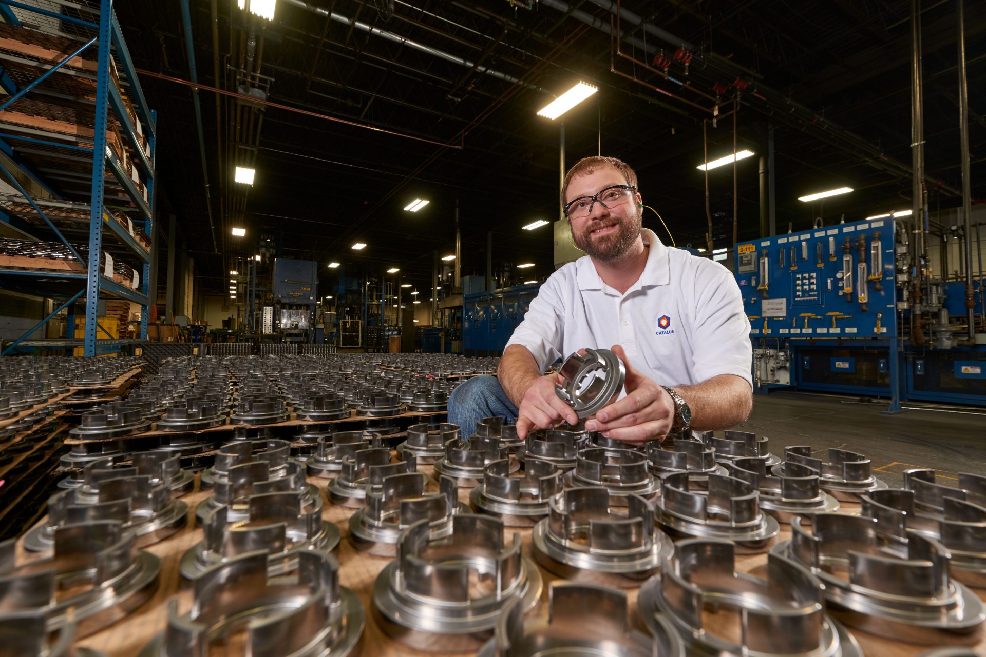 Plant manager Joe Glass poses with automotive parts manufactured by Catalus Corp. (Photo provided by Dave Parsons)