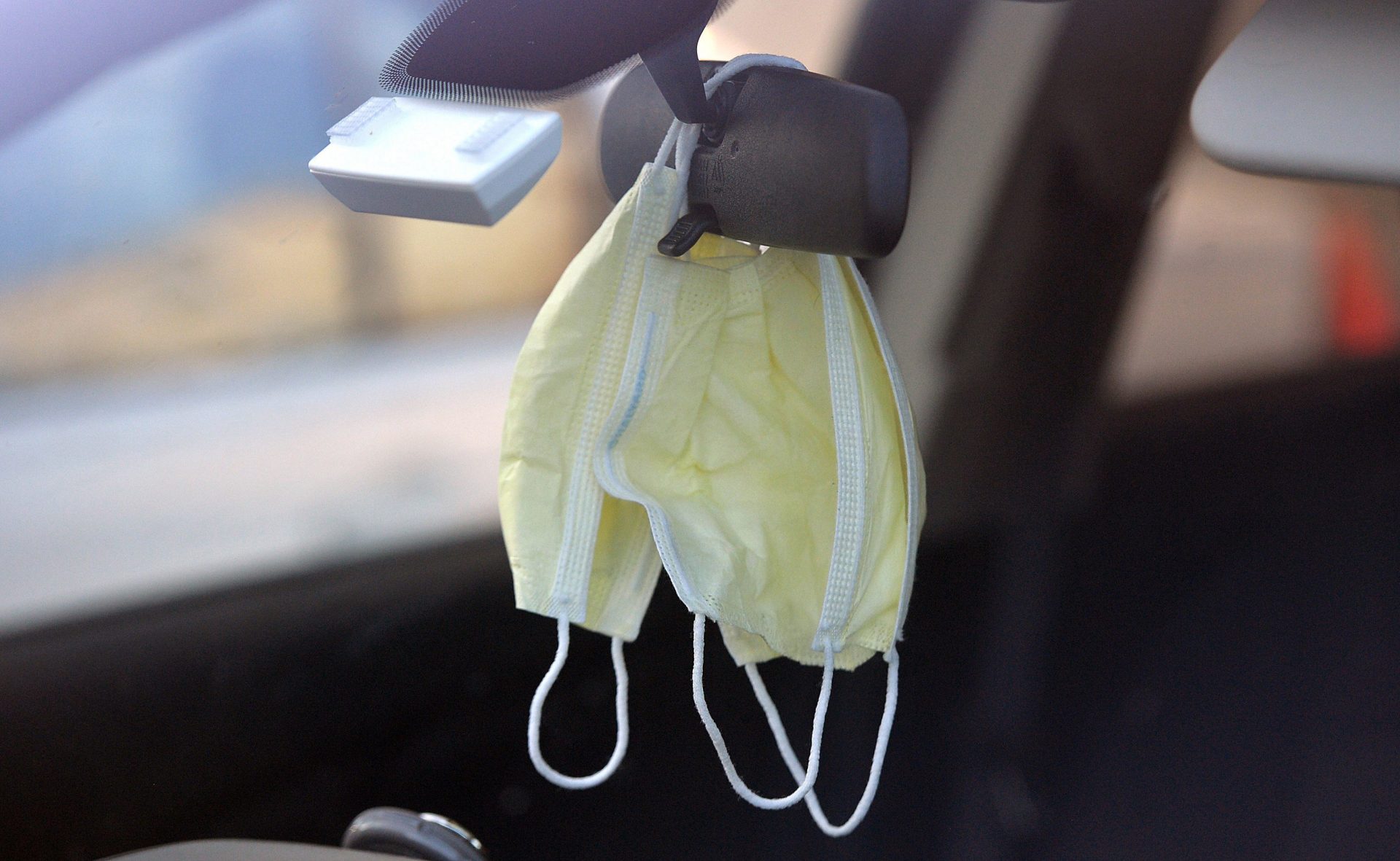 Face masks hang from the rearview mirror of a vehicle Friday, May 1, 2020, in Fairview Township, Pa., during the coronavirus pandemic. (Christopher Millette/Erie Times-News via AP)