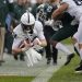 Penn State quarterback Sean Clifford, left, dives for a first down against Michigan State’s Shakur Brown (29) during the first quarter of an NCAA college football game, Saturday, Oct. 26, 2019, in East Lansing, Mich. (AP Photo/Al Goldis)