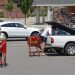 A woman and man wear COVID-19 protective masks as she pushes her shopping cart and a man loads his truck in a parking lot, Friday, July 3, 2020, in McCandless, Pa.  Keith Srakocic / AP Photo