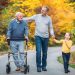 Elderly father adult son and grandson out for a walk in the park.