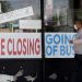 FILE - In this May 21, 2020 file photo, a man looks at signs of a closed store due to COVID-19 in Niles, Ill. U.S. businesses shed 2.76 million jobs in May, as the economic damage from the historically unrivaled coronavirus outbreak stretched into a third month. The payroll company ADP reported Wednesday that businesses have let go of a combined 22.6 million jobs since March.  Nam Y. Huh / AP Photo