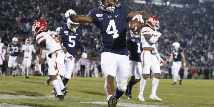 Penn State running back Journey Brown (4) celebrates his third quarter touchdown run against Rutgers during an NCAA college football game in State College, Pa., on Saturday, Nov. 30, 2019. Penn State defeated Rutgers 27-6. (AP Photo/Barry Reeger)