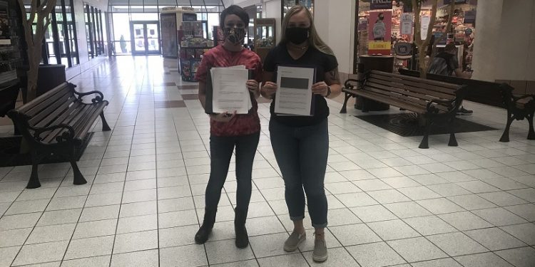 Students Tamara Seltzler, left, and Paige Pleta distributing surveys to members of the community at the DuBois Mall.  They distributed surveys for the public to complete both locally, and in communities across the country. (Provided photo)