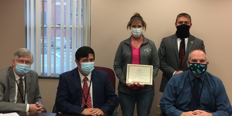 Pictured, in front, are Commissioners John A. Sobel, Tony Scotto, chairman, and Dave Glass. In the back are: 911 dispatcher Vicky Hoover and District Attorney Ryan Sayers. (Photo by GANT News Editor Jessica Shirey)