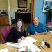 Danielle Parks, president of the MVEMS board of directors, and Wes Cartwright, one of the managers at MVEMS, sign the final paperwork to acquire 2.3 acres of land at the former Philipsburg Area Hospital Site, now the Philipsburg Area Commerce Park.  (Provided photo)