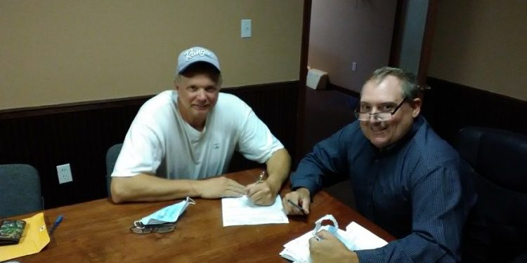 Pictured are John Moore of Sewer Catt LLC and Attorney Dave Thompson, as they wrap up the signing of the paperwork for the purchase of land in the Moshannon Valley Regional Business Park. (Provided photo)