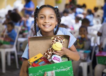 A girl in the Dominican Republic shows off the “wow” toy she received in her shoebox gift. (Photo courtesy of Samaritan’s Purse)