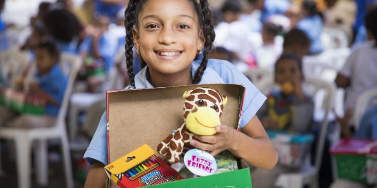 A girl in the Dominican Republic shows off the “wow” toy she received in her shoebox gift. (Photo courtesy of Samaritan’s Purse)