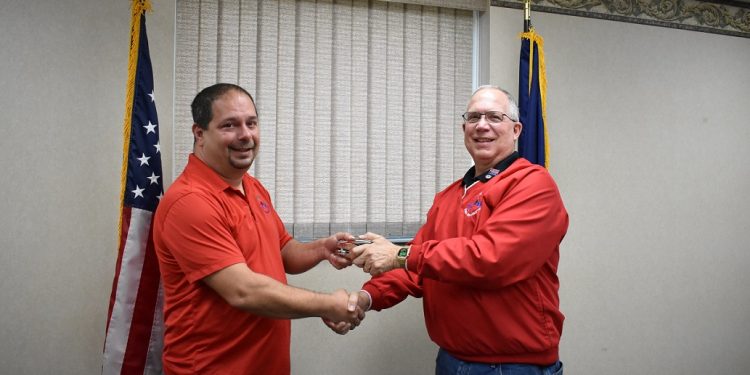 Dana Smith, president/CEO emeritus is pictured transferring ownership of KMA Remarketing® Corporation’s corporate seal to newly elected President/CEO, Ken Allshouse. (Provided photo)