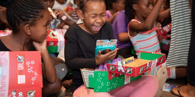 Sheer joy overwhelms a girl in the African nation of Namibia as she opens her gift-filled shoebox. (Photo courtesy of Samaritan’s Purse)