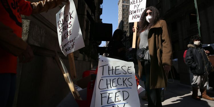 Michelle Perry of Philadelphia protested outside Gov. Tom Wolf's Center City office earlier this month, demanding "a working unemployment system to provide timely responses and benefits to unemployed workers."

DAVID MAIALETTI / Philadelphia Inquirer