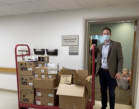 Justin Maxfield, administrative fellow at Geisinger Medical Center, transports donated items delivered by GIANT/Martin’s through the hospital in preparation of offering the items to pediatric nurses during National Nurses Week. (Provided photo)