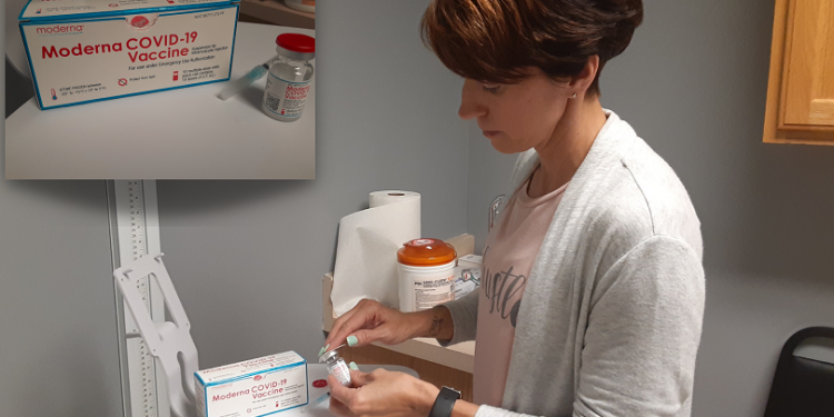 Practice Manager Megan Patrick, RN, RD, NHA, prepares to administer an initial dose of the Moderna COVID-19 vaccine. (Provided photo)