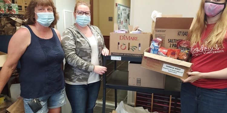 From left, are Missy McKeown, custodian; Casey Friberg, secretary; and Nora Campbell, student; at the Clearfield Campus Cupboard.