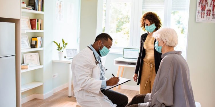 Close up of a senior woman and her daughter having a doctors appointment