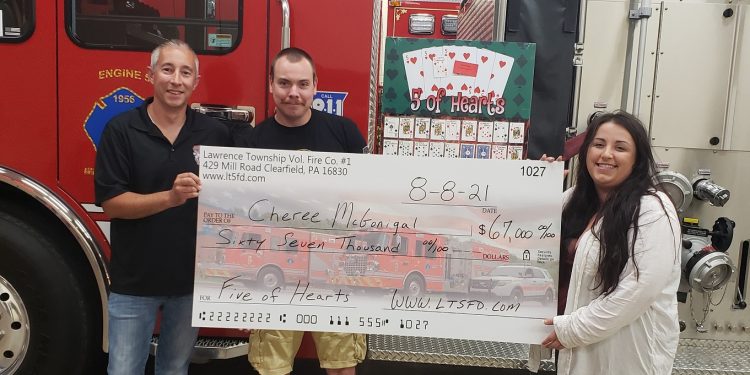 Pictured, from left, are: Jeremy Ruffner, assistant chief; Elliott Neeper, deputy chief; and prize winner Cheree McGonigal. (Provided photo)