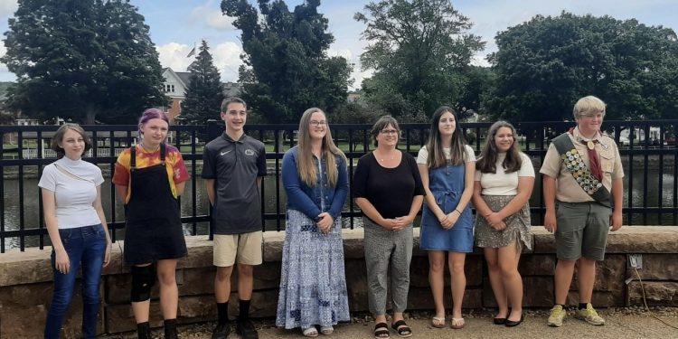 Middle and High School Poetry Contest winners are pictured, from left to right:  Alastor Tornatore, Emily McTavish, Brennan Michael, Lillian Neff, Library Director Lisa Coval, Jaycee Wood, Abigail Simcox and Cole Spencer. (Provided photo)