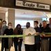 To celebrate the opening of the Trophy Room bar and restaurant at Graduate State College, Jessica Jacoby McCloskey, Director of Sales, cuts the CBICC ribbon surrounded by CBICC members and fellow team members Kyra Ebersole, Banquet Manger, Will Thomas, Chef, and Brian Walker, Bar & Restaurant Manager.