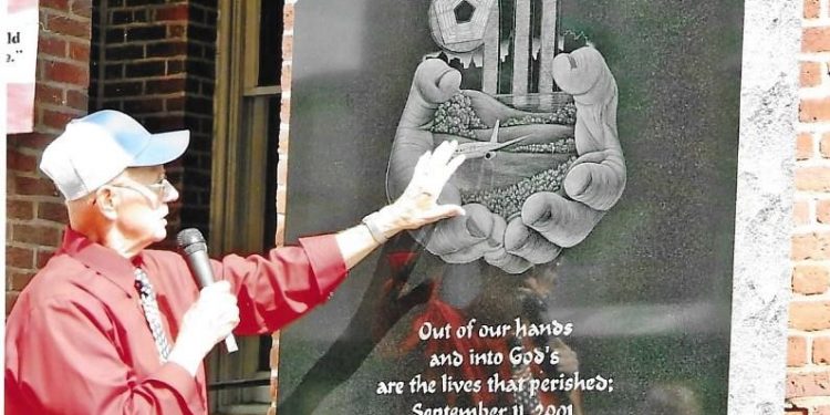 During Clearfield’s ceremony remembering the 10th anniversary of Sept. 11 in 2011, a special memorial stone was dedicated. Marven Smith, shown here pointing out the special artwork, spearheaded the committee that planned the celebration which included a parade as well as the events at the county courthouse and the unveiling of the new stone, which stands as a reminder of that sad day. (Photo courtesy of Marven Smith)