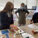 DCC student, Raegan Porter works on printing with ink while Matthew Zorn, BCAT Artist-in-Residence for the 2021-2022 school year and fellow student, Serena Mullins observe. (Provided photo)