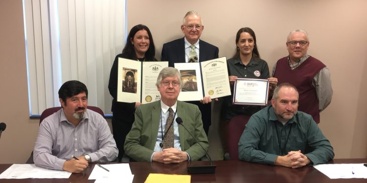 Pictured, in front from left, are: Commissioners Tony Scotto, John A. Sobel, board chairman, and David Glass. In the back, from left, are: Andrea Schickling, from the Clearfield office of State Sen. Wayne Langerholc Jr., Don Schmidt, Champion of the PA Wilds Award recipient, LaKeshia Knarr, entrepreneurial ecosystem director, PA Wilds Center for Entrepreneurship Inc., and Nick Hoffman, PA Wilds Center board member. (Photo by Jessica Shirey, GANT News Editor)