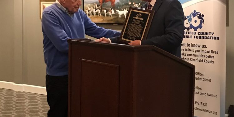 Bob Kurtz is presented a plaque from CCCF Board Chairman Kevin McMillen in recognition of the leadership and support Kurtz and his wife, Marilyn, have provided to the Charitable Foundation. (Provided photo)