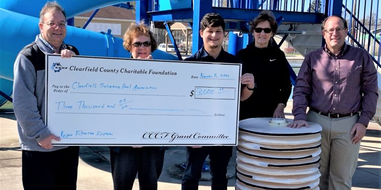 Presenting a 2021 CCCF Grant to the Clearfield Swimming Pool Association is CCCF Executive Director Mark McCracken with Pool Association members, Margaret “Lady” Putt, Pool Association Vice President; Tristen Buck, pool manager; Becky Johnson, Pool Association treasurer; and Brian Marshall, Pool Association president, pictured with one of the new replacement filters.    Accepting the grant, Marshall said: “The Clearfield Swimming Pool Association appreciates the $3,000 grant award from the Clearfield County Charitable Foundation. The grant will help the association pay the cost of much-needed new covers for the pool filters, which should last about 20 years.  The support of the community, including the foundation, helps keep the pool affordable for the people of Clearfield County.” (Provided photo)