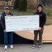 Mark McCracken, executive director of the Clearfield County Charitable Foundation presents Dalton Kendrick from the Clearfield Skate Park Committee a CCCF grant to help fund the ramp purchase and installation.   The new ramp is pictured in the background. (Provided photo)