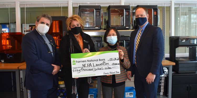 Farmers National Bank Regional Manager Eric Funk and DuBois Branch Manager Kelli Allison present a $50,000 check to Penn State DuBois Interim Chancellor Ping Werner and NCPA LaunchBox Director Brad Lashinsky.  Their gift establishes the Farmers National Bank Endowment in support of the North Central PA LaunchBox powered by Penn State DuBois. The group is pictured in front of just some of the 3-D printers housed in the on-campus Idea Lab, where prototypes of new products can be brought to life for budding entrepreneurs.