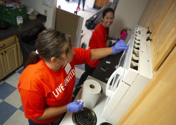Lori Delbo, left, and Angela Comis, both of Penn State Health Milton S. Hershey Medical Center, help clean the kitchen of a residential apartment of the YWCA of Greater Harrisburg during the 2019 United Way Day of Caring. (NOTE: This photo was taken prior to enactment of safety protocols related to COVID-19.)