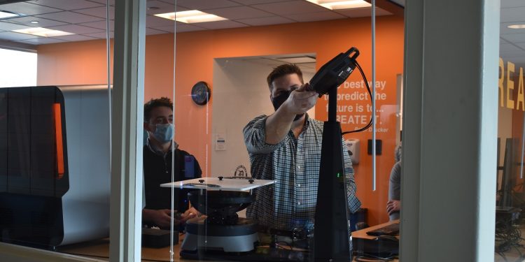 Instructor for the Rapid Prototyping course at Penn State DuBois, Johnny Williams, becomes familiar with the new turntable 3-D printer in the on-campus Idea Lab, while Damon Johnson of Cimquest Inc. guides the training process.