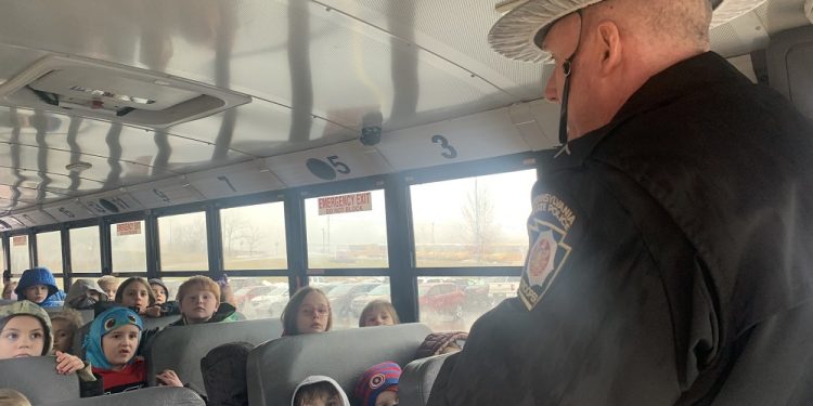 Trooper Bruce Morris addresses first graders at Clearfield Area Elementary School on the topic of school bus safety.