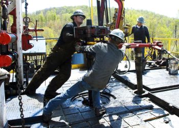 In this April 23, 2010, file photo, workers move a section of well casing into place at a Chesapeake Energy natural gas well site near Burlington, Pa., in Bradford County.  Ralph Wilson/AP Photo
