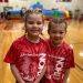 DCC first-graders Everleigh Roy and Nora Rice enjoy the new inflatable slides at Cardinal-thon 2022. (Provided photo)
