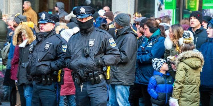 Two Philadelphia Police officers stand in front of crowd of spectators on Broad Street during the New Years Day Mummers Parade on Jan. 1, 2020. Hiring of officers, and retention of them, was the focal point of a hearing Monday.

Alan Budman / Shutterstock