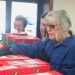 Jane Davis, Prayer Team coordinator, prays over shoebox gifts during 2021 National Collection Week at West Central PA’s Central Drop-off in Curwensville.